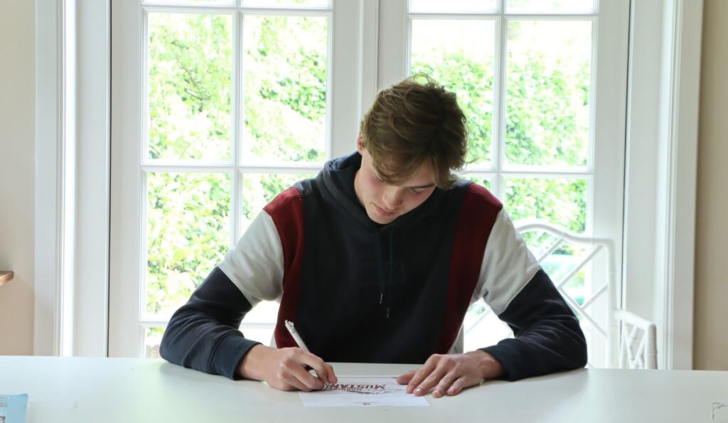 Marnix van Exel preparing at home to leave for the U.S. after signing a scholarship with Morningside College