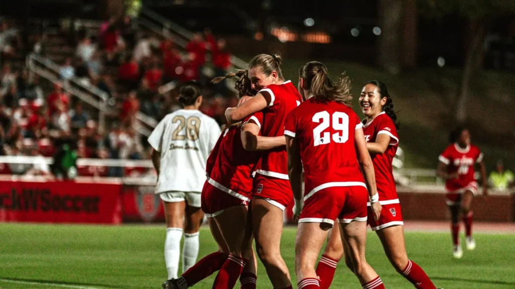 Student-athlete Fien Leijdekker celebrates a moment of success with her North Carolina State University soccer team during a college soccer match in America.