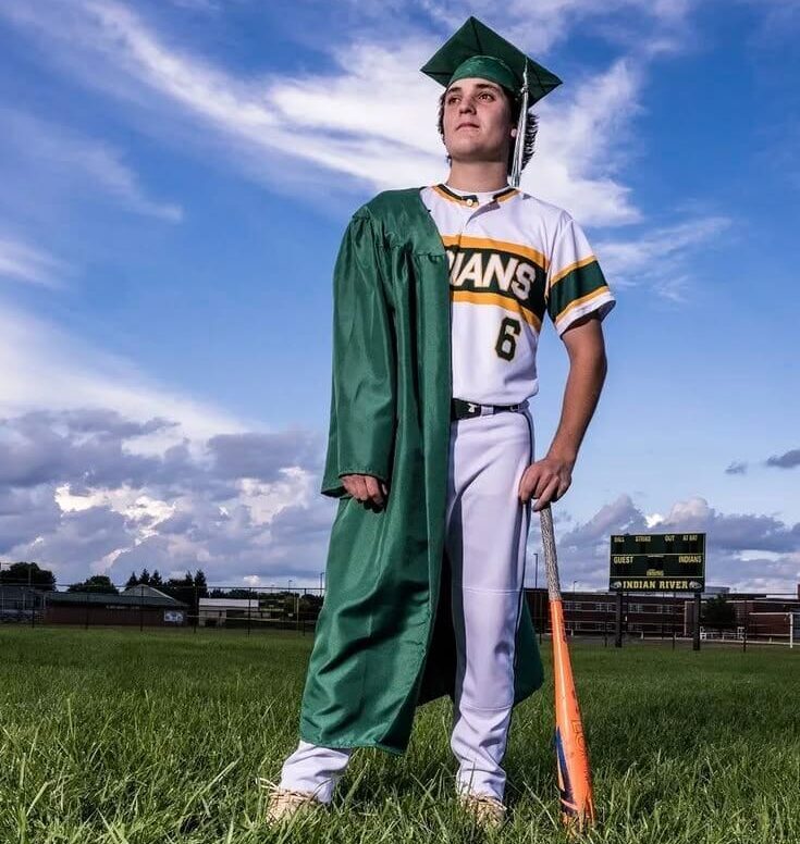 Graduating as a Student-Athlete in America College baseball player celebrating his graduation on a baseball field in America