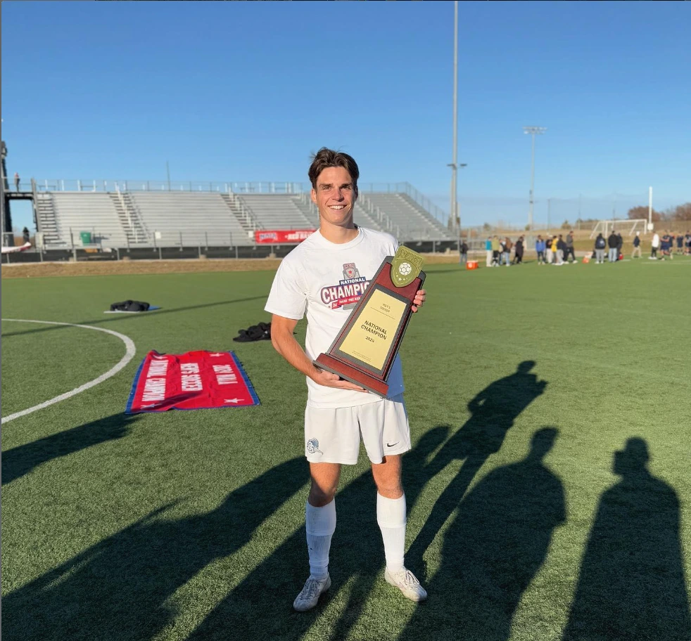 Jip van den Essen, a Dalton State University student-athlete holding the NAIA National Championship trophy
